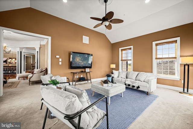 living area featuring visible vents, decorative columns, vaulted ceiling, carpet flooring, and ceiling fan with notable chandelier