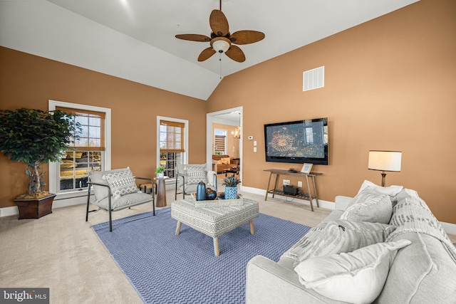 carpeted living area with visible vents, a ceiling fan, baseboards, and vaulted ceiling