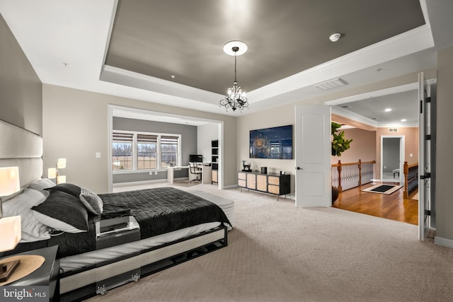 carpeted bedroom with visible vents, baseboards, a chandelier, ornamental molding, and a raised ceiling