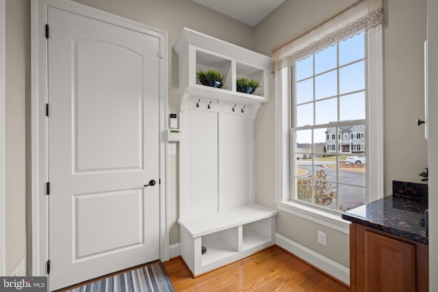 mudroom with light wood finished floors and baseboards