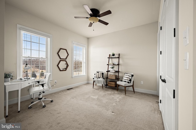 carpeted office space with visible vents, baseboards, and a ceiling fan