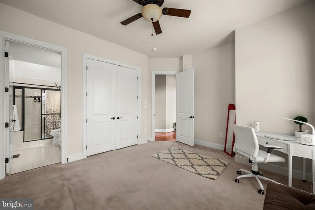 unfurnished office featuring a ceiling fan, carpet, and baseboards