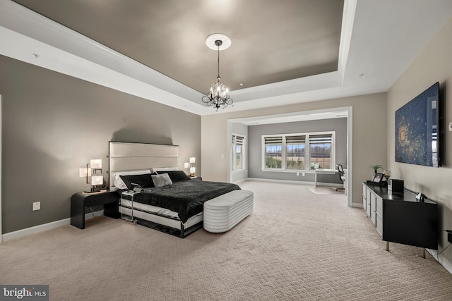 bedroom with an inviting chandelier, a tray ceiling, baseboards, and light carpet