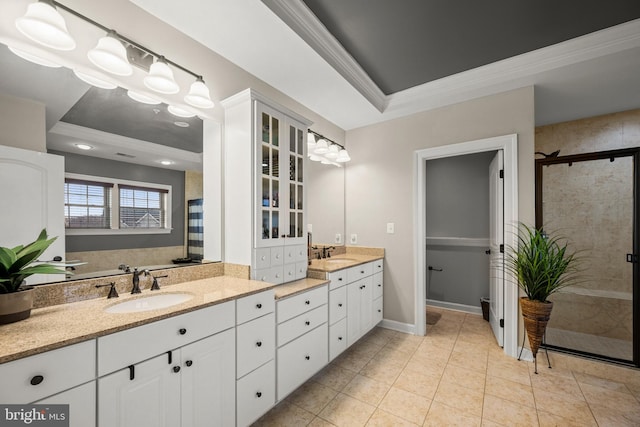 bathroom featuring vanity, a shower stall, crown molding, a raised ceiling, and tile patterned floors