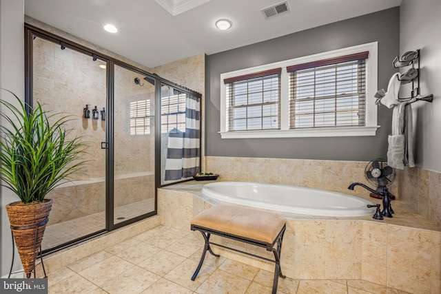 bathroom with tile patterned floors, a bath, visible vents, and a stall shower