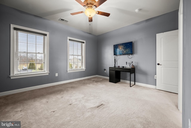 interior space featuring visible vents, a ceiling fan, baseboards, and carpet floors