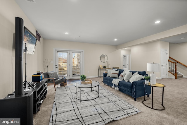 living area featuring stairs, recessed lighting, baseboards, and light carpet