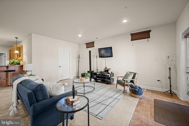 living room with light tile patterned flooring, recessed lighting, and baseboards