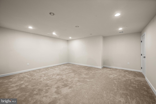 finished basement with visible vents, recessed lighting, baseboards, and carpet floors