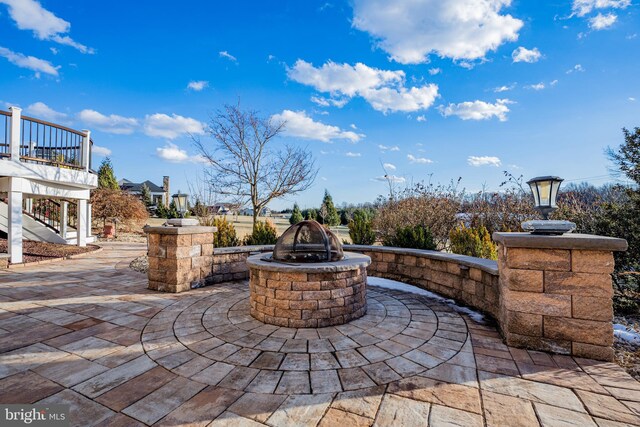 view of patio with a fire pit and stairs