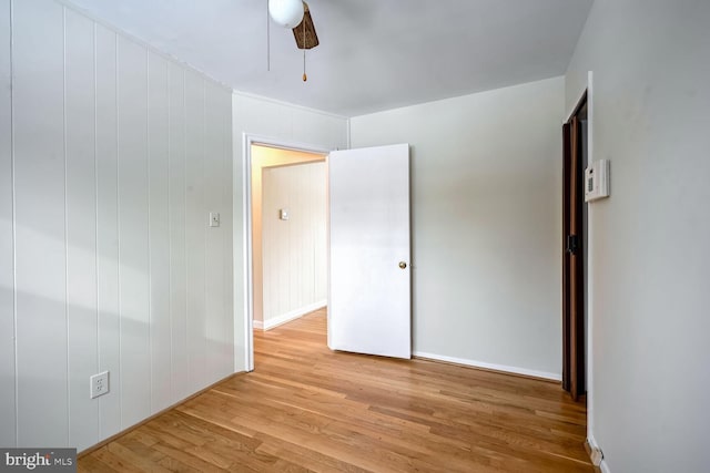 empty room with light wood-type flooring and ceiling fan