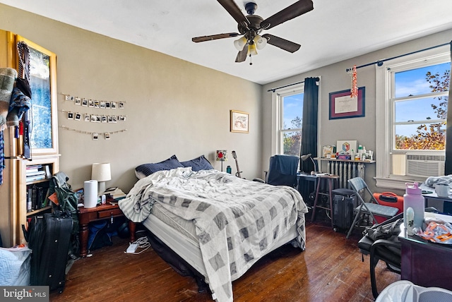 bedroom with ceiling fan, cooling unit, and dark hardwood / wood-style flooring