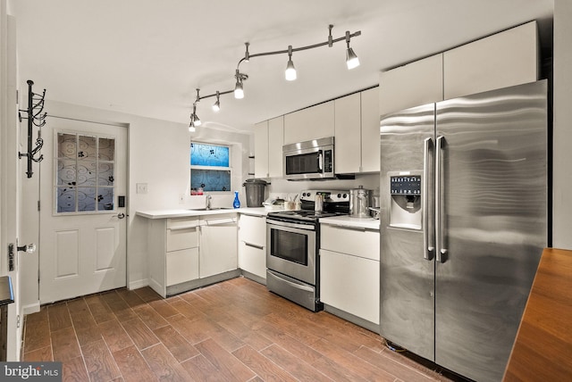 kitchen featuring white cabinets, sink, and stainless steel appliances