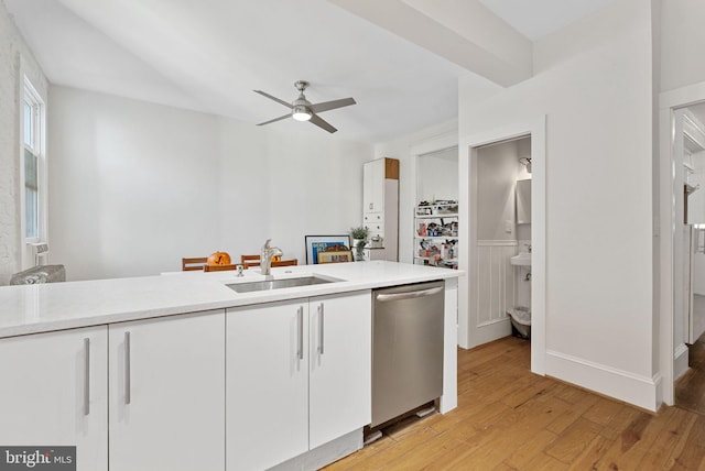 kitchen featuring light wood-type flooring, ceiling fan, sink, dishwasher, and white cabinetry