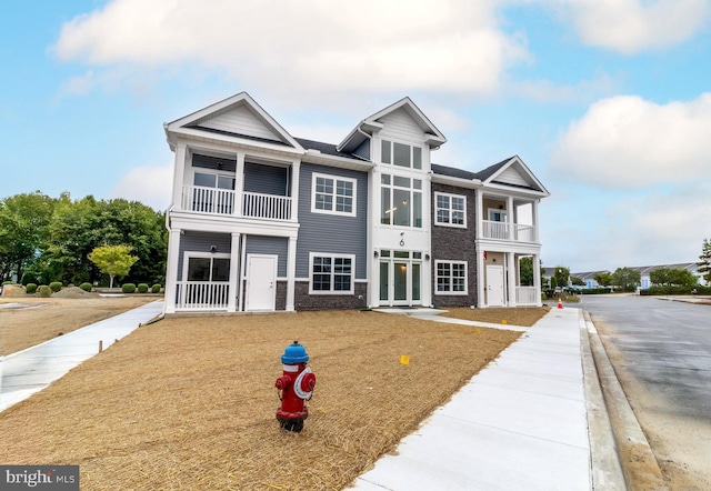 view of front of house featuring a balcony