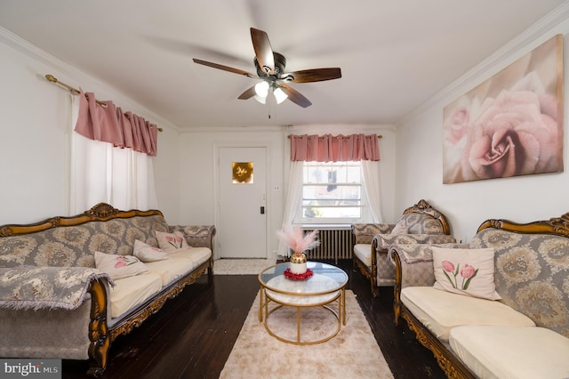 living room with hardwood / wood-style flooring, ceiling fan, and crown molding