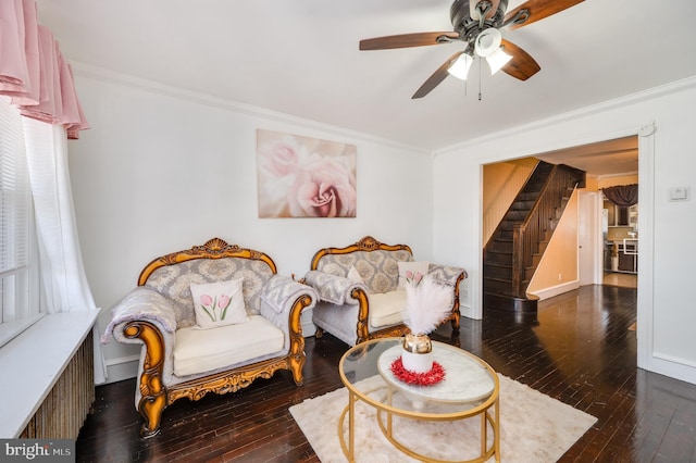 living room with crown molding, ceiling fan, and dark wood-type flooring