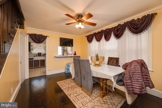 dining area featuring a healthy amount of sunlight, ceiling fan, wood-type flooring, and ornamental molding