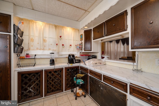 kitchen with dark brown cabinets and light tile patterned floors