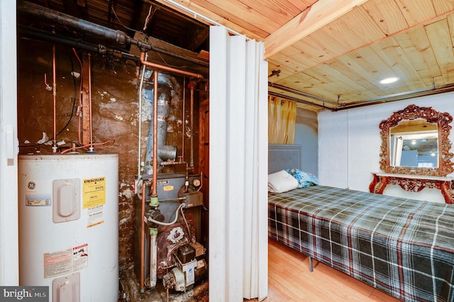 bedroom with electric water heater, beamed ceiling, wood-type flooring, and wooden ceiling