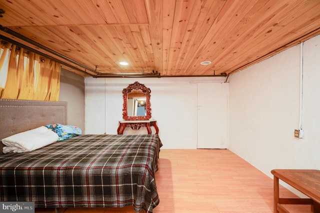 bedroom with wooden ceiling and hardwood / wood-style flooring