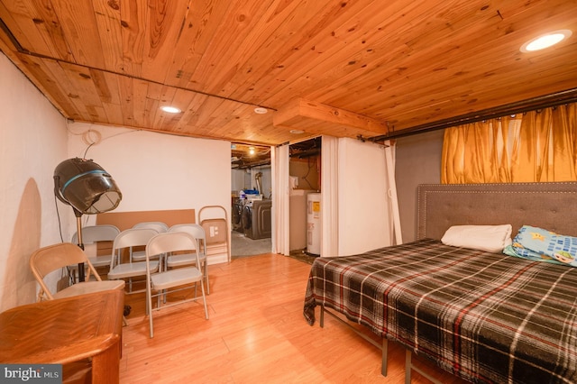 bedroom with electric water heater, washer / dryer, wooden ceiling, and hardwood / wood-style floors