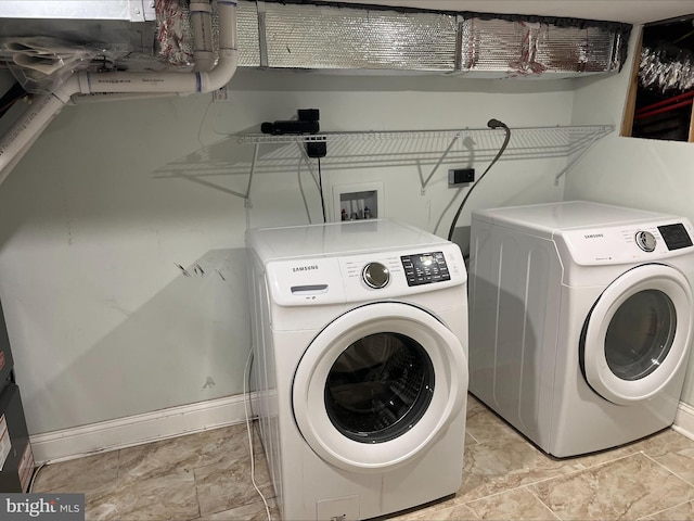 washroom with washer and dryer