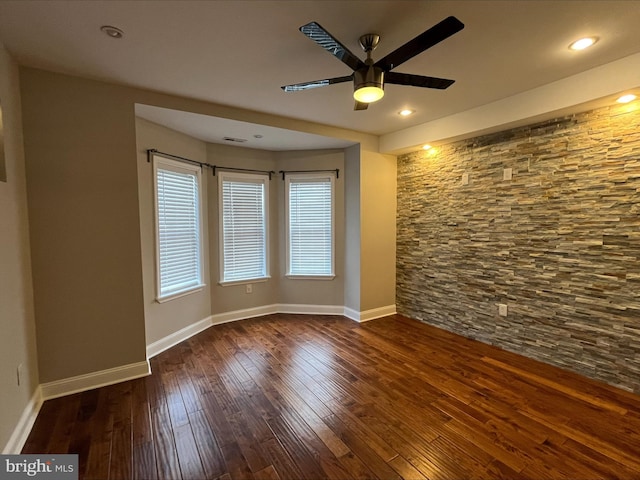 empty room featuring ceiling fan and dark hardwood / wood-style floors