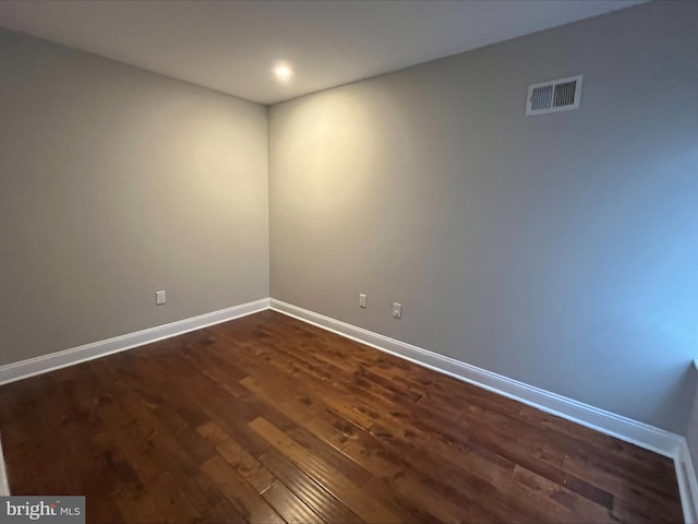 unfurnished room featuring dark wood-type flooring