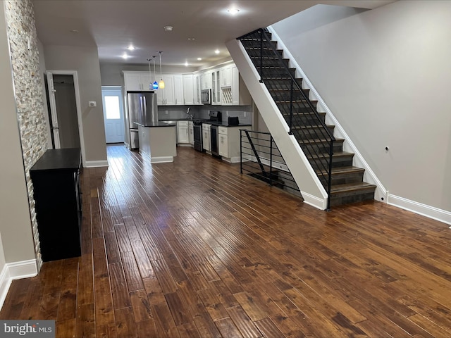 unfurnished living room featuring dark wood-type flooring