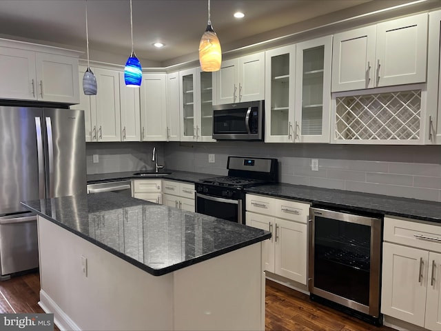 kitchen featuring sink, stainless steel appliances, dark wood-type flooring, wine cooler, and decorative light fixtures