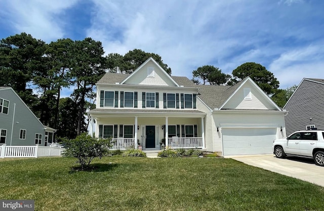 view of front of home with a porch, a garage, and a front yard