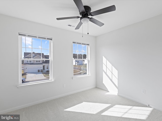 carpeted empty room featuring ceiling fan