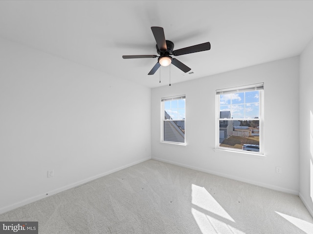 empty room with light colored carpet and ceiling fan