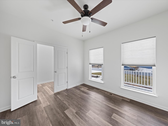 unfurnished bedroom with ceiling fan and dark hardwood / wood-style floors