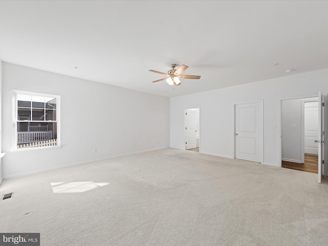 interior space with ceiling fan and light carpet