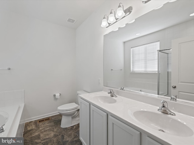 bathroom with a relaxing tiled tub, vanity, and toilet