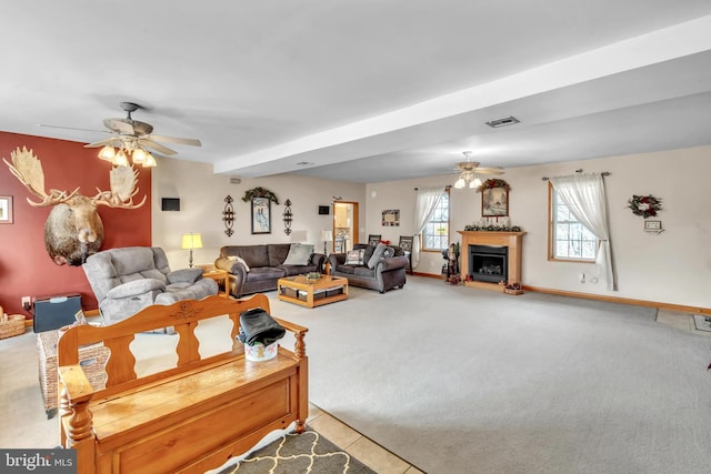 living room featuring carpet, ceiling fan, and beamed ceiling