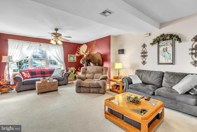 carpeted living room with ceiling fan