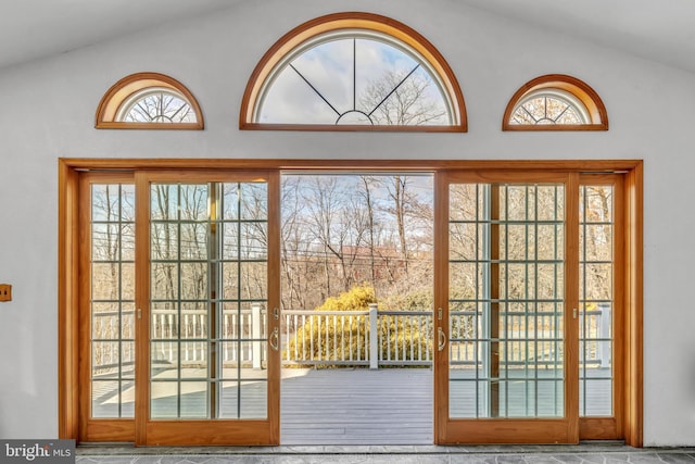 doorway to outside with vaulted ceiling