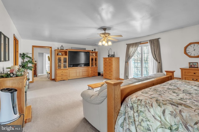 bedroom featuring ceiling fan and light colored carpet