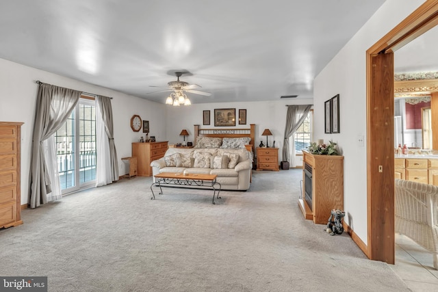 carpeted bedroom featuring ceiling fan, access to exterior, and connected bathroom