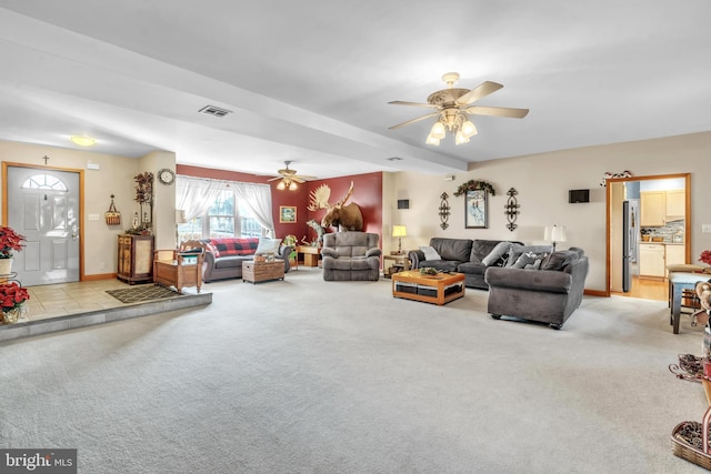 carpeted living room featuring ceiling fan and beam ceiling