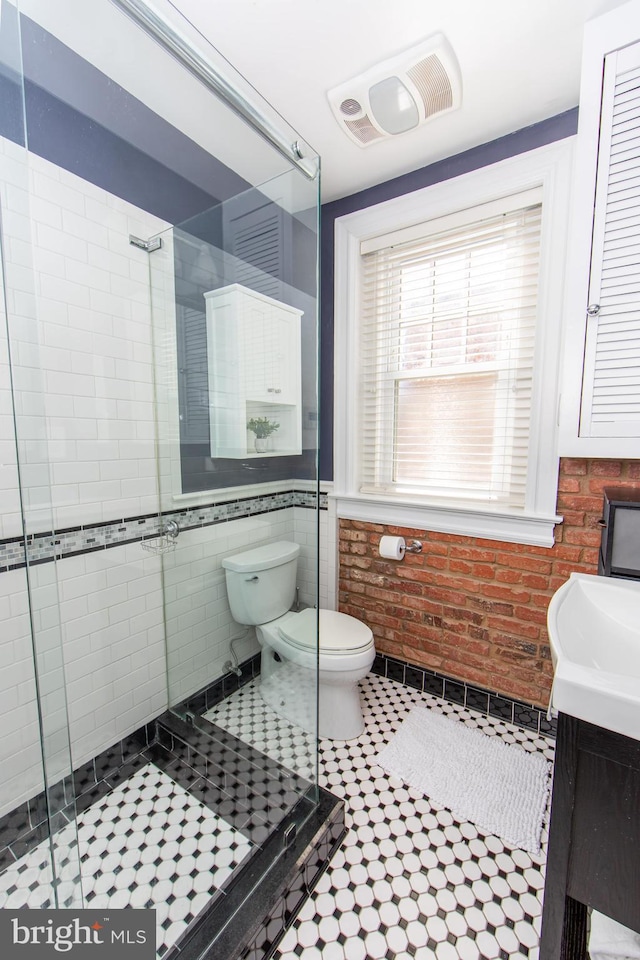 full bath featuring visible vents, a shower stall, brick wall, and toilet