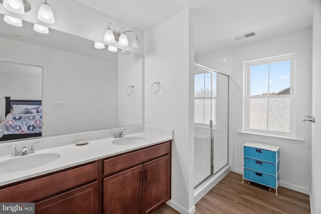 bathroom with hardwood / wood-style flooring, vanity, and walk in shower