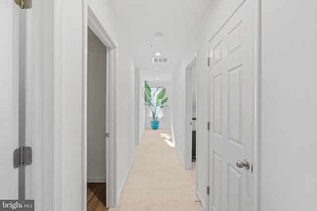 hallway featuring light carpet