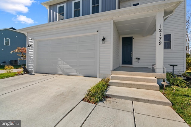 view of front of property featuring central AC and a garage