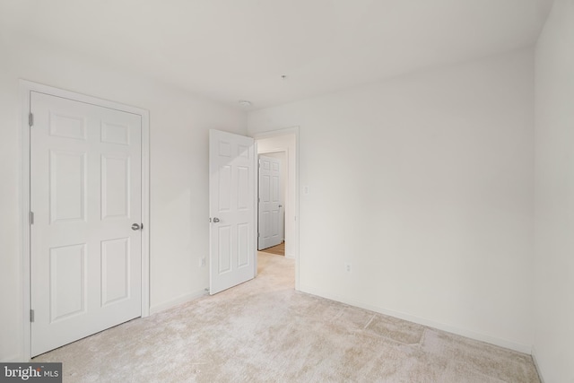 unfurnished bedroom featuring light colored carpet