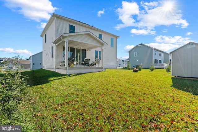 rear view of property with a yard and a patio