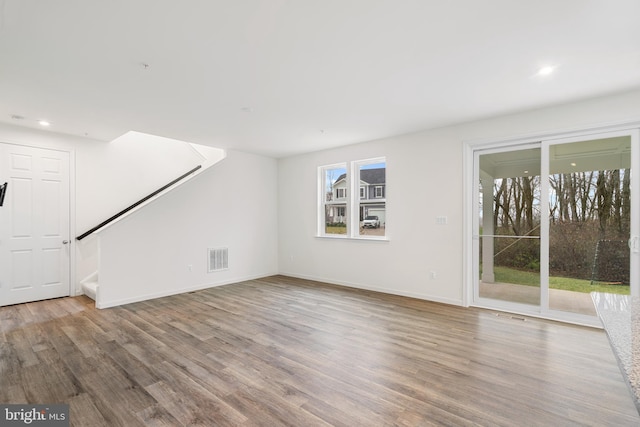 unfurnished living room featuring hardwood / wood-style flooring